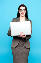 Image showing Young active businesswoman working on laptop