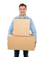 Image showing Young man holding cardboard boxes