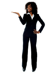 Image showing Corporate african lady presenting copy space