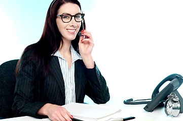 Image showing Female customer care executive holding mic