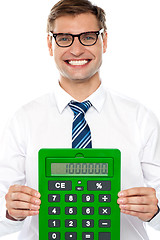 Image showing Corporate man showing big green calculator