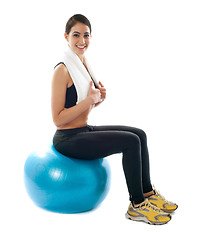 Image showing Female fitness trainer sitting on ball