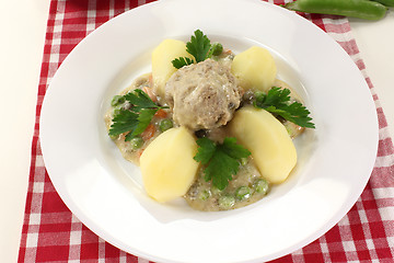 Image showing cooked meatballs in a white sauce with capers