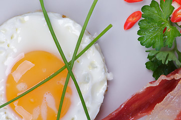 Image showing Fried Eggs Sunny Side Up with Bacon, Parsley and Lettuce