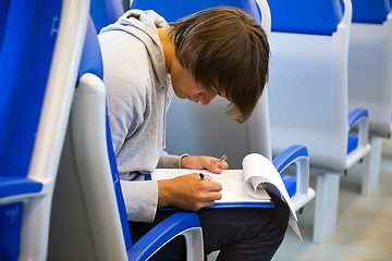 Image showing Filling out an itinerary in a train