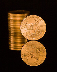 Image showing Reflection of one ounce gold coin black