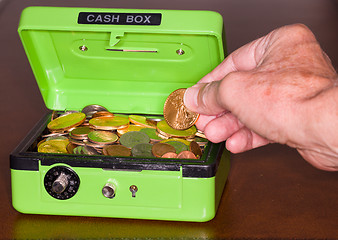 Image showing Green cash box with gold and silver coins