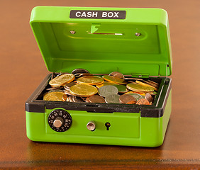 Image showing Green cash box with gold and silver coins