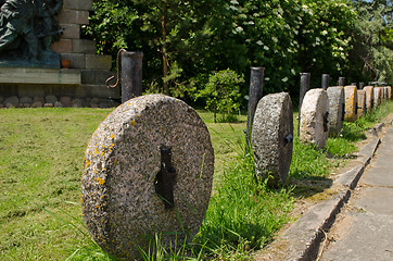 Image showing Retro rock millstones hang. Car park decorations 