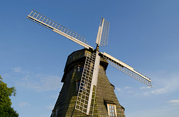 Image showing Retro wooden mill  wings against blue sky 