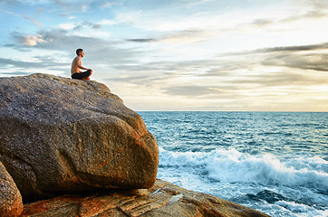 Image showing Man practices yoga on coast - meditation