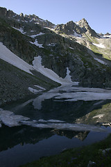 Image showing Lake in mountains. Alpine latitudes at different times of the ye