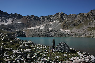 Image showing Lake in mountains. Alpine latitudes at different times of the ye