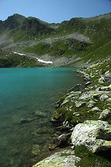 Image showing Lake in mountains. Alpine latitudes at different times of the ye