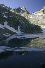 Image showing Lake in mountains. Alpine latitudes at different times of the ye