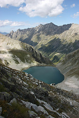 Image showing Lake in mountains. Alpine latitudes at different times of the ye