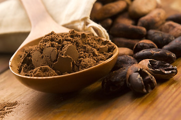 Image showing Cocoa (cacao) beans on natural wooden table