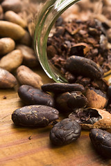 Image showing Cocoa (cacao) beans on natural wooden table