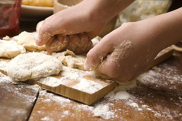 Image showing Detail of hands kneading dough