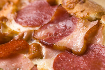 Image showing Italian pizza with bacon, salami and mozzarella cheese