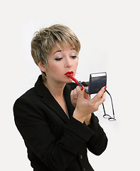 Image showing Businesswoman fixing her makeup