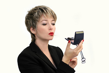 Image showing Businesswoman fixing her makeup