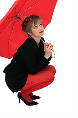 Image showing Businesswoman with a red umbrella