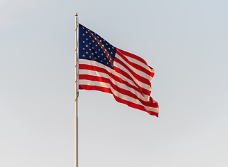 Image showing American Flag Flying in front of a clear sky