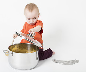 Image showing baby with big cooking pot