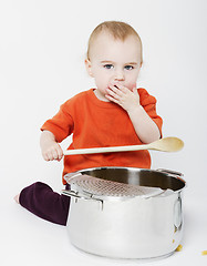 Image showing baby with big cooking pot and wooden spoon