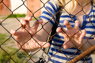 Image showing Woman hands claw rusty fence. Human freedom stop 