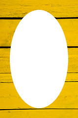 Image showing Wall made of yellow wooden planks and white oval 