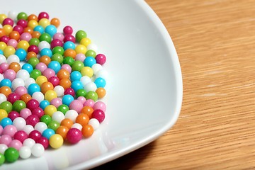 Image showing colored sugar balls on a white plate