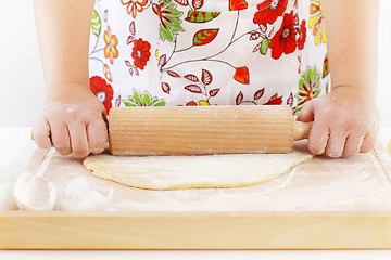 Image showing Woman rolling dough using rolling pin