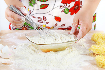 Image showing Woman mixing dough