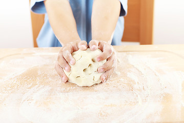 Image showing Child kneading dough