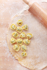 Image showing Dough with raw tortellini and rolling pin