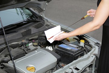 Image showing Woman checking oil engine level 2