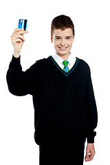 Image showing School boy holding credit card