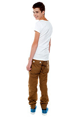 Image showing Trendy young boy turning back