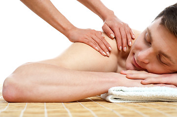 Image showing Handsome male getting spa massage