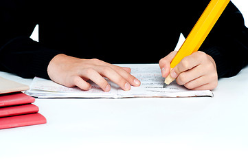 Image showing Closeup shot of school boy doing homework