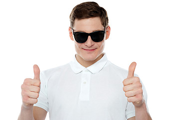 Image showing Handsome guy gesturing double thumbs up