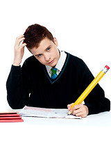 Image showing Confused young school boy thinking