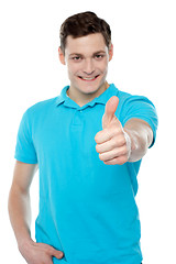 Image showing Handsome casual smiling guy showing thumbs up