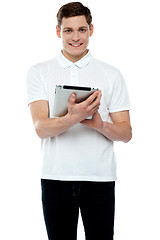 Image showing Casual teen operating touch screen device