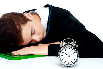 Image showing Tired schoolboy sleeping on calculator