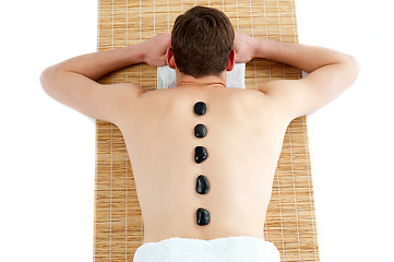 Image showing Man receiving hot stone therapy massage