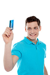 Image showing Handsome young man holding credit card
