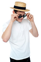 Image showing Man looking from behind sunglasses and smiling